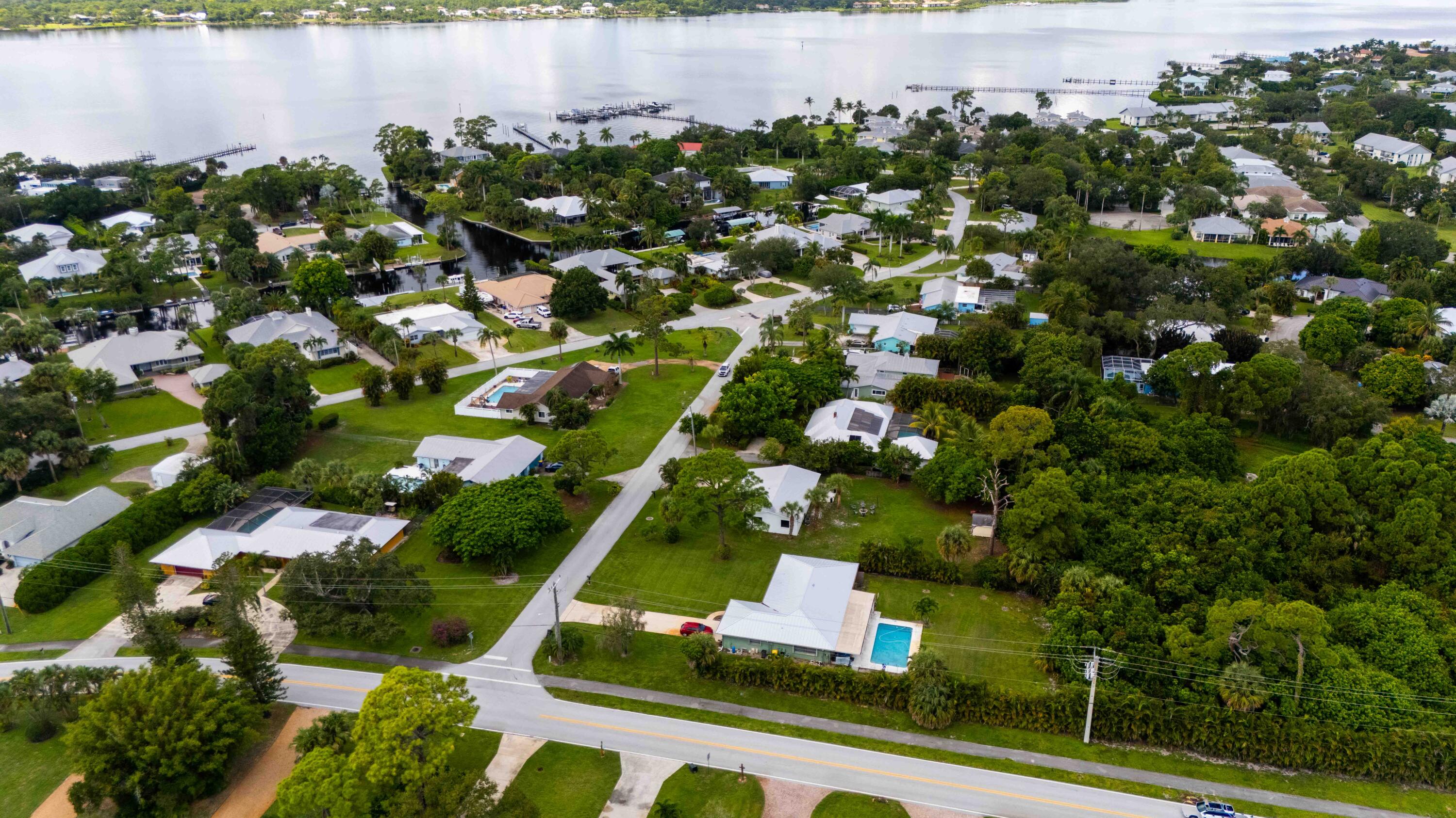1849 Northwest Pine Tree Way Stuart, FL 34994 - Photo 29 of 29 an aerial view of residential houses with outdoor space and lake view