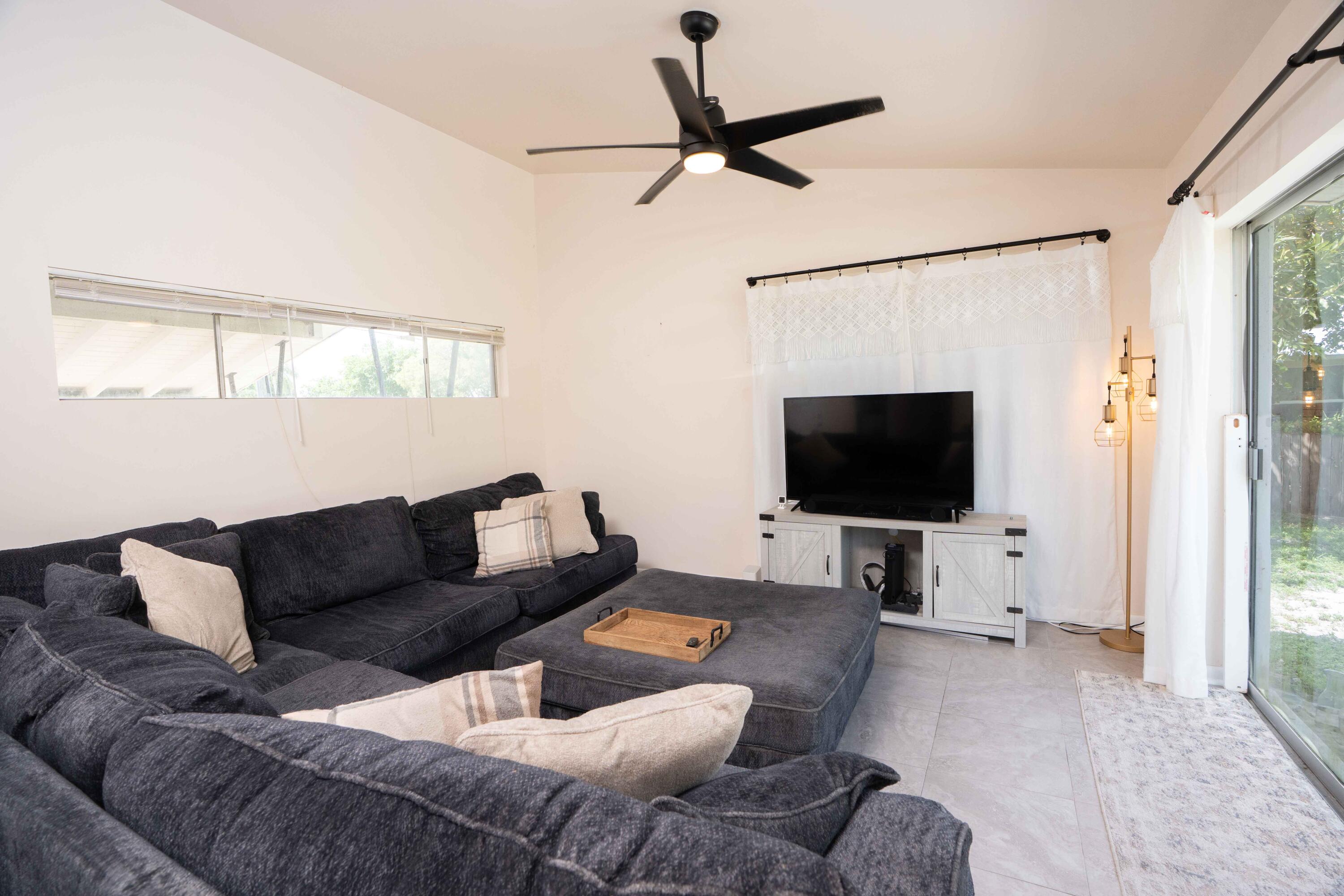 1849 Northwest Pine Tree Way Stuart, FL 34994 - Photo 5 of 29 a living room with furniture and a flat screen tv