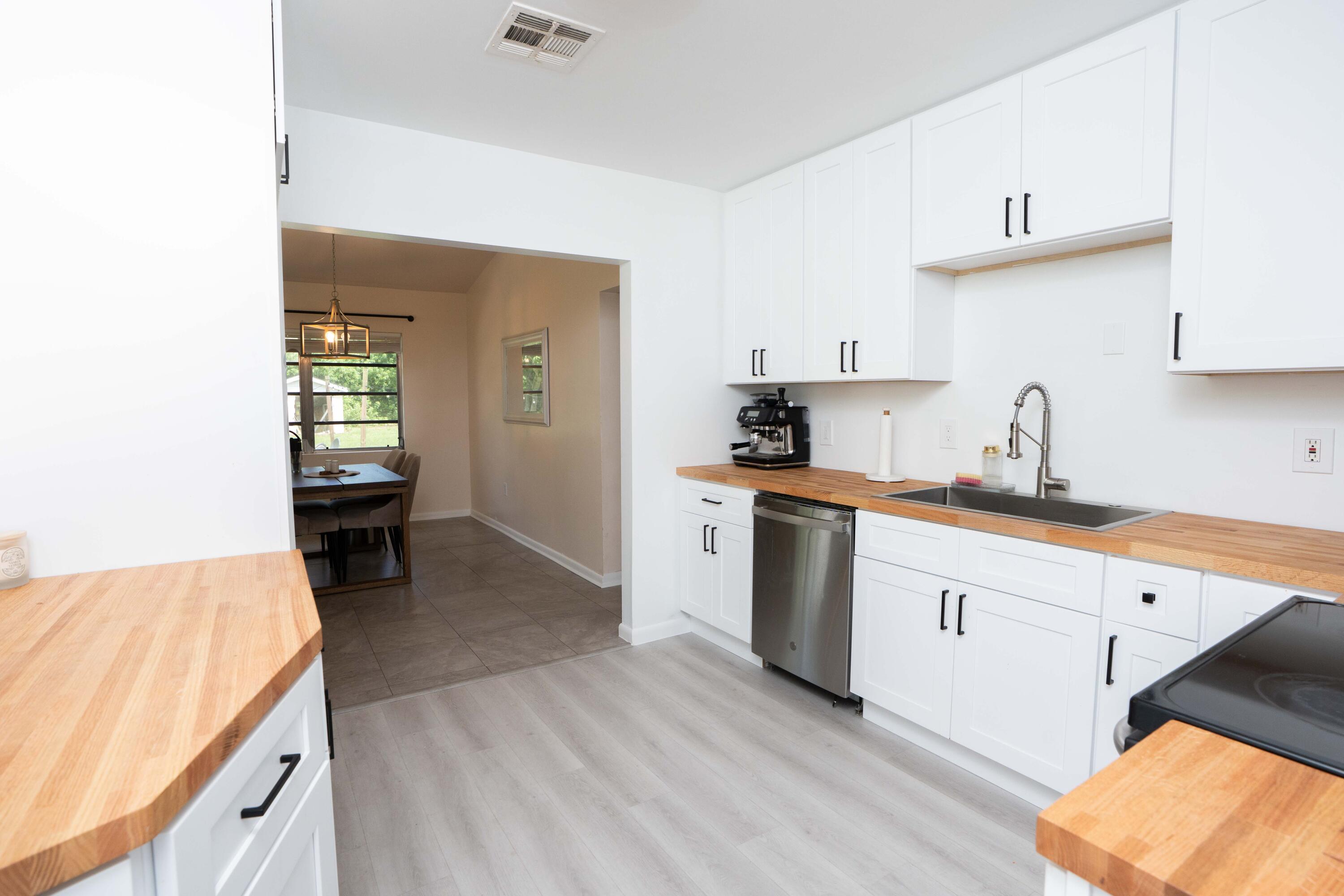 1849 Northwest Pine Tree Way Stuart, FL 34994 - Photo 7 of 29 a kitchen with sink and cabinets