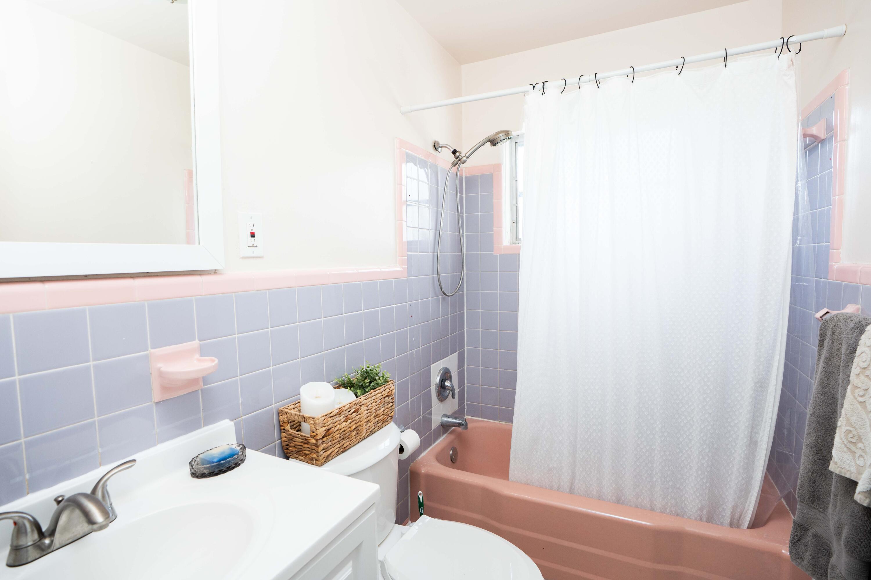 1849 Northwest Pine Tree Way Stuart, FL 34994 - Photo 10 of 29 a bathroom with a sink and a shower curtain