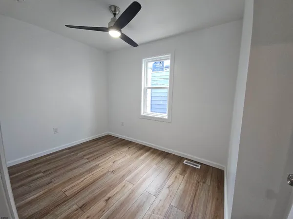 a view of a room with wooden floor