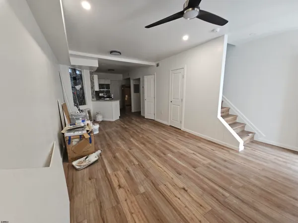 a view of a room with gym equipment and wooden floor