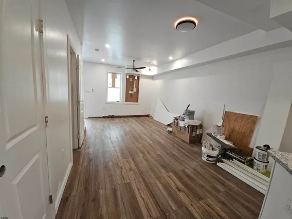 a view of a room with wooden floor