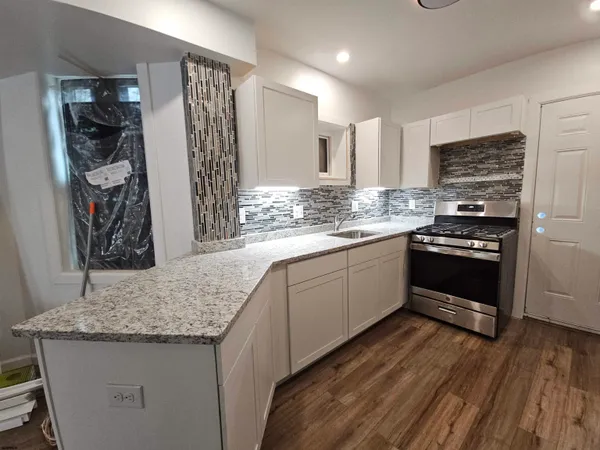 a kitchen with a sink stove and cabinets