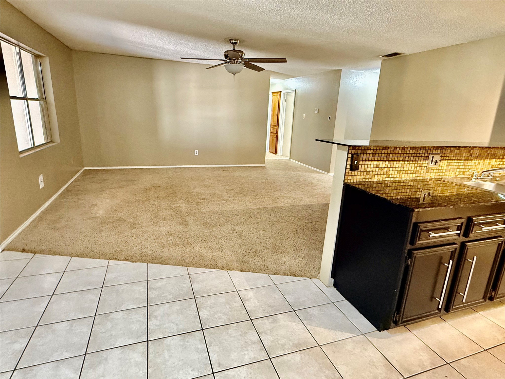 2206 87th Street Lubbock, TX 79423 - Photo 3 of 13 a view of a refrigerator in kitchen and an empty room