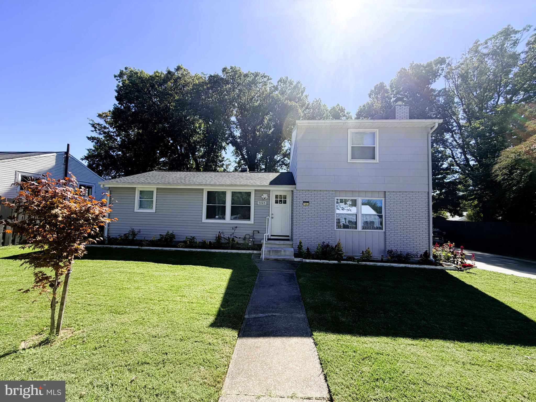 7403 S Road Rosedale, MD 21237 - Photo 1 of 27 a front view of a house with a garden