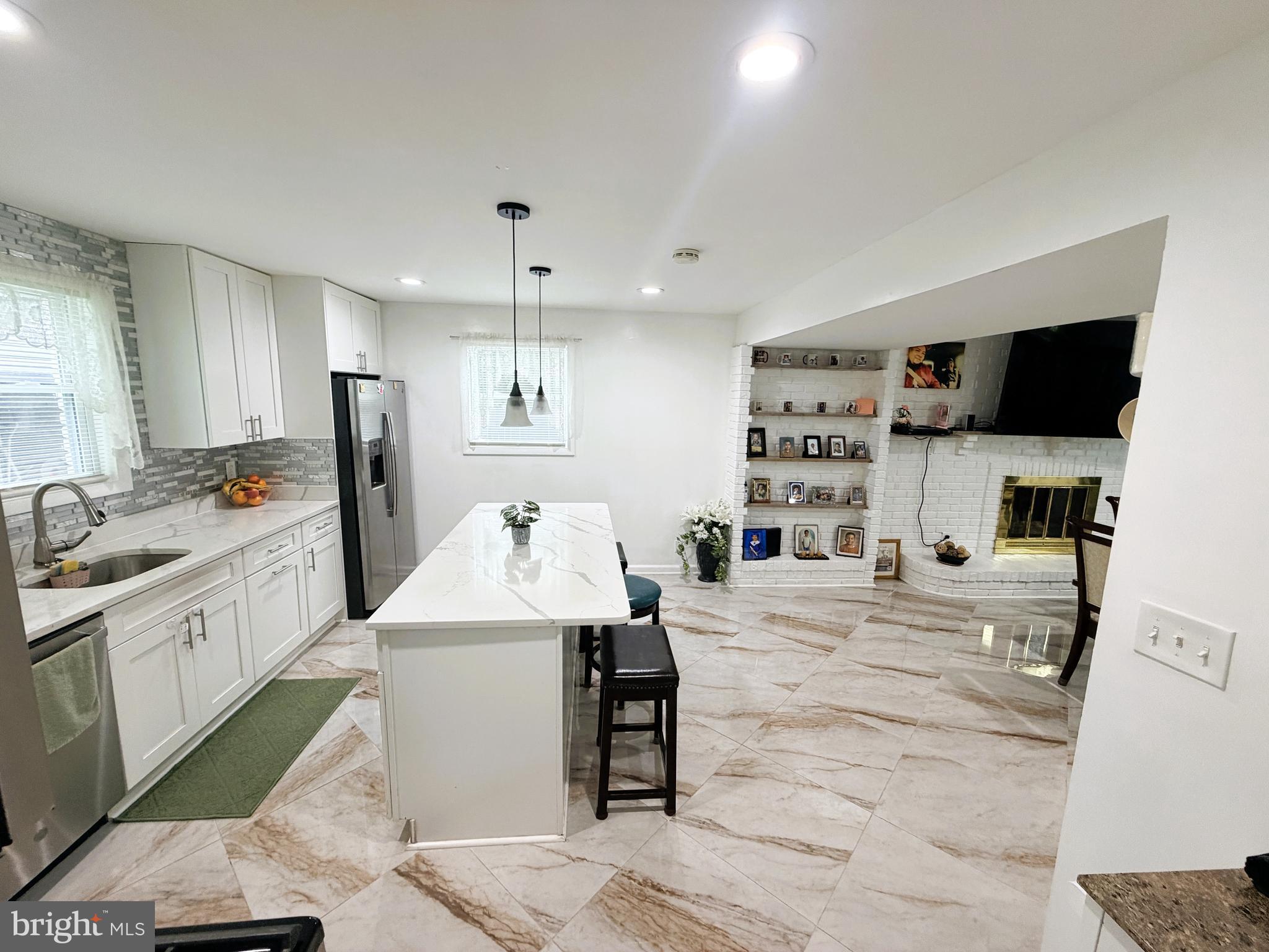 7403 S Road Rosedale, MD 21237 - Photo 11 of 27 a large white kitchen with cabinets and stainless steel appliances