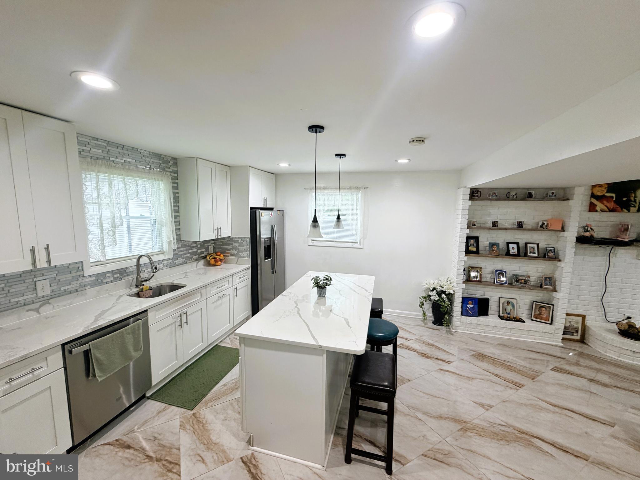 7403 S Road Rosedale, MD 21237 - Photo 12 of 27 a open kitchen with stainless steel appliances granite countertop a sink and cabinets