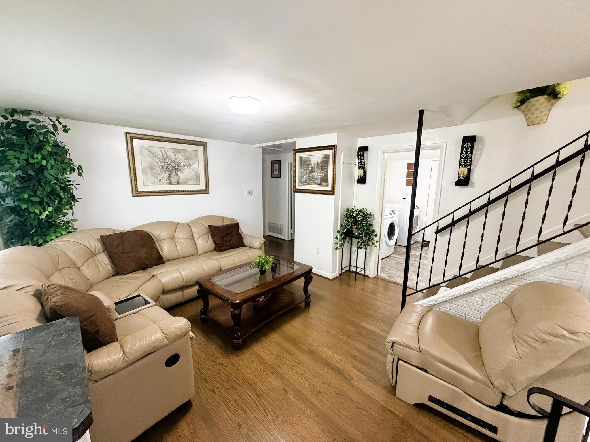 7403 S Road Rosedale, MD 21237 - Photo 13 of 27 a living room with furniture and wooden floor