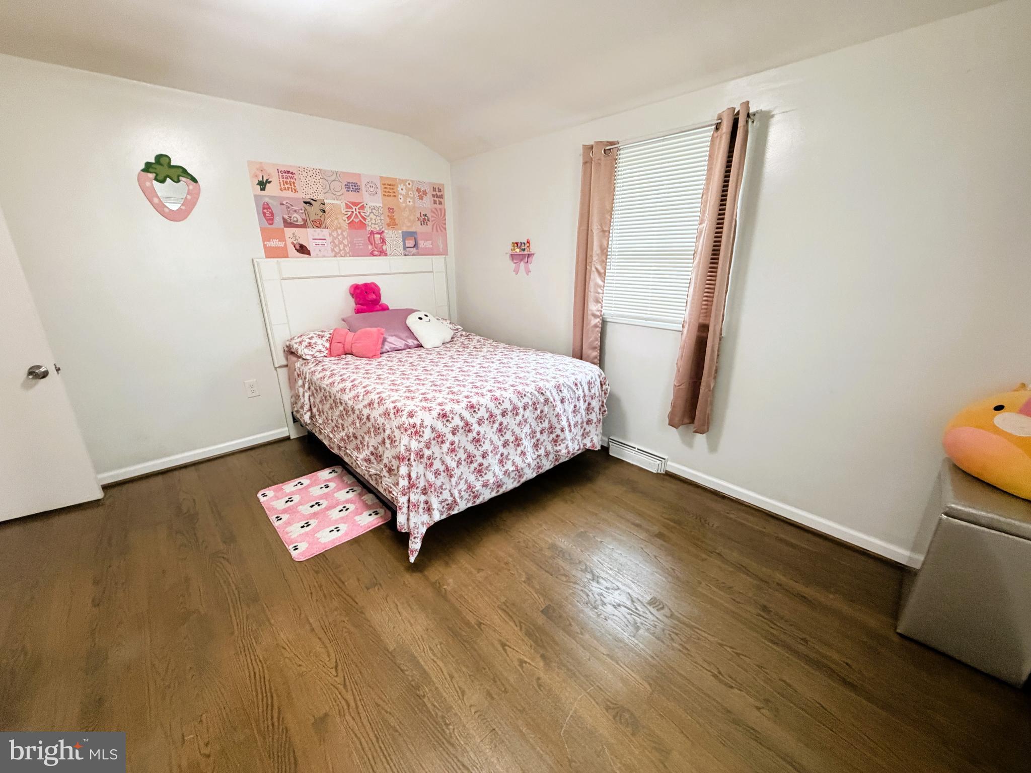 7403 S Road Rosedale, MD 21237 - Photo 19 of 27 a bedroom with a bed and a wooden floor