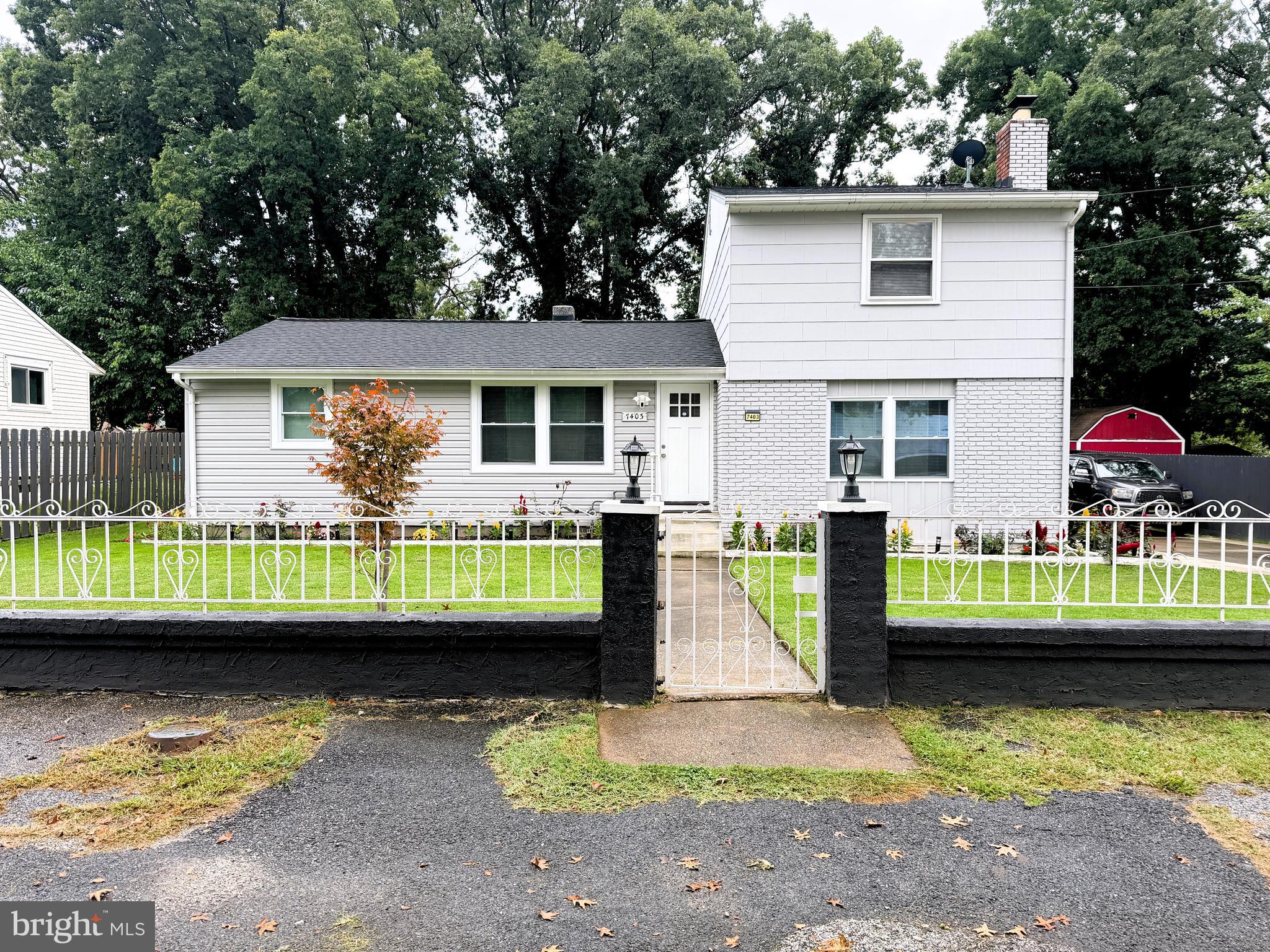7403 S Road Rosedale, MD 21237 - Photo 4 of 27 a front view of house with a garden and swimming pool