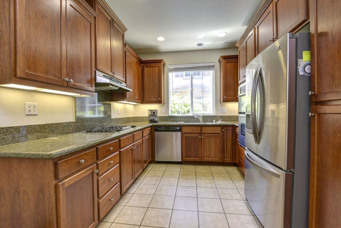 5373 Fioli Loop San Ramon, CA 94582 - Photo 8 of 31 a kitchen with stainless steel appliances granite countertop a refrigerator and a sink