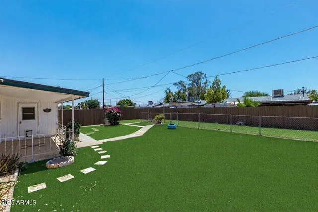 an empty room with wooden floor and ceiling fan