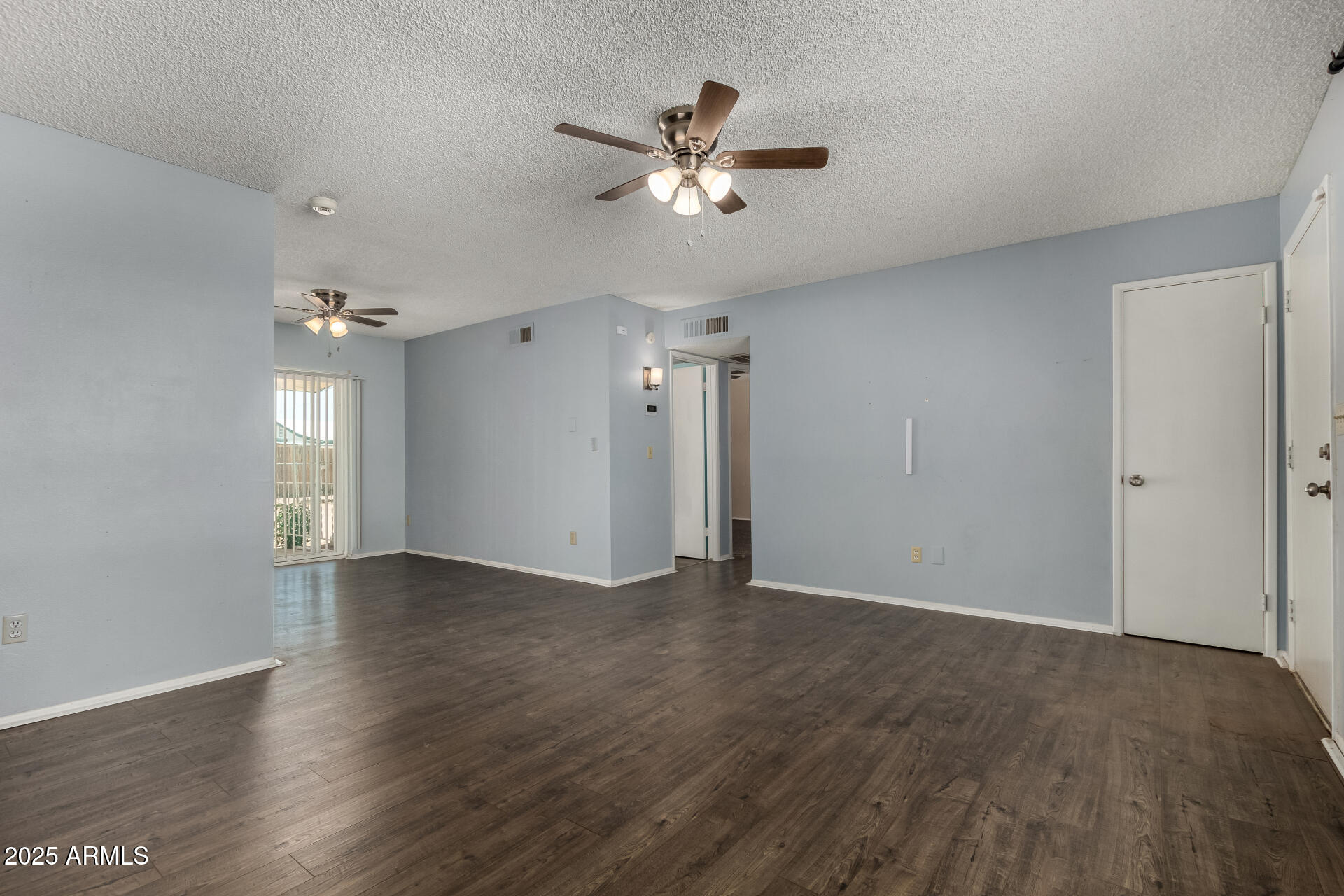 1510 South Lawther Drive Apache Junction, AZ 85120 - Photo 19 of 30 an empty room with wooden floor and ceiling fan