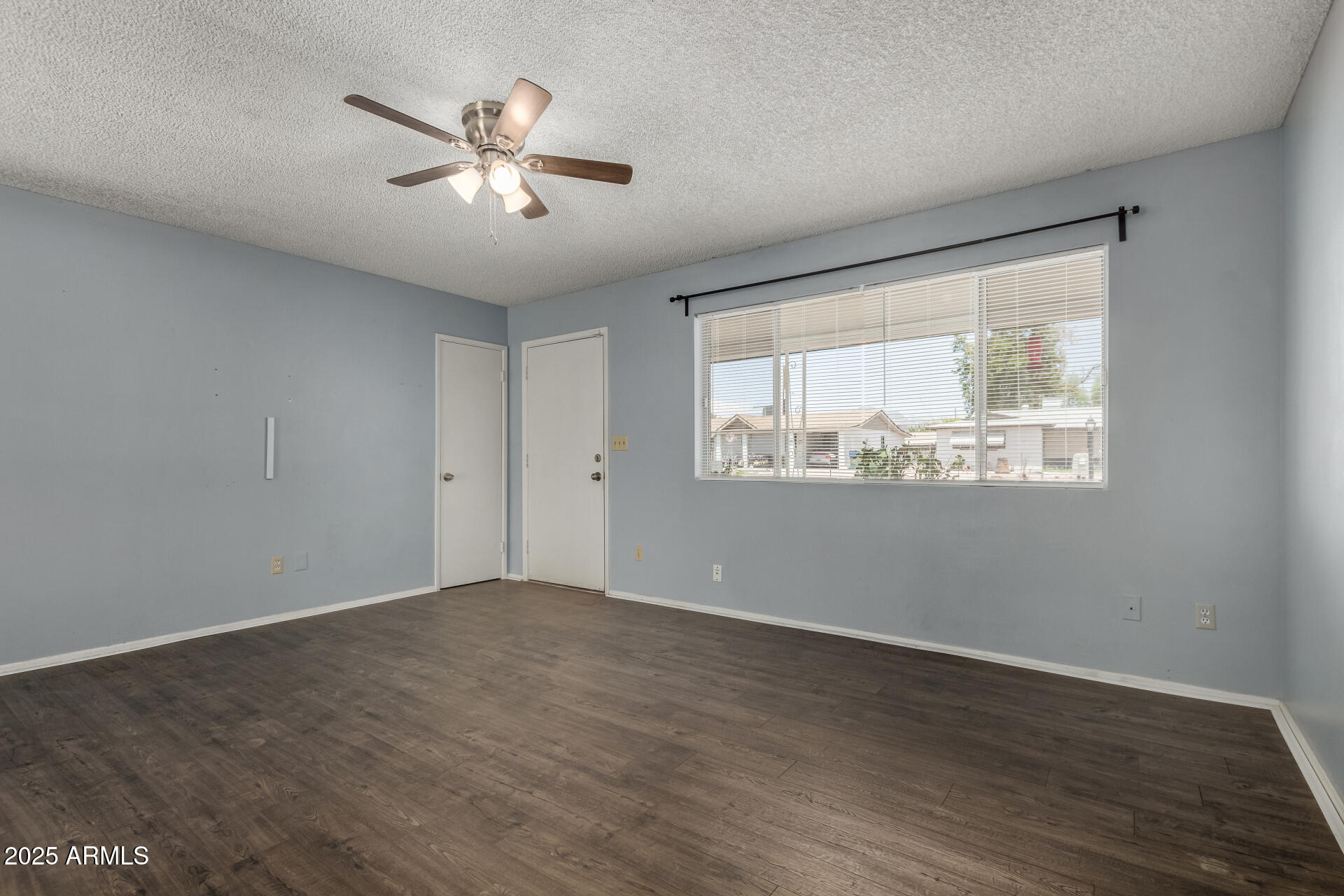 1510 South Lawther Drive Apache Junction, AZ 85120 - Photo 21 of 30 wooden floor in an empty room with a window