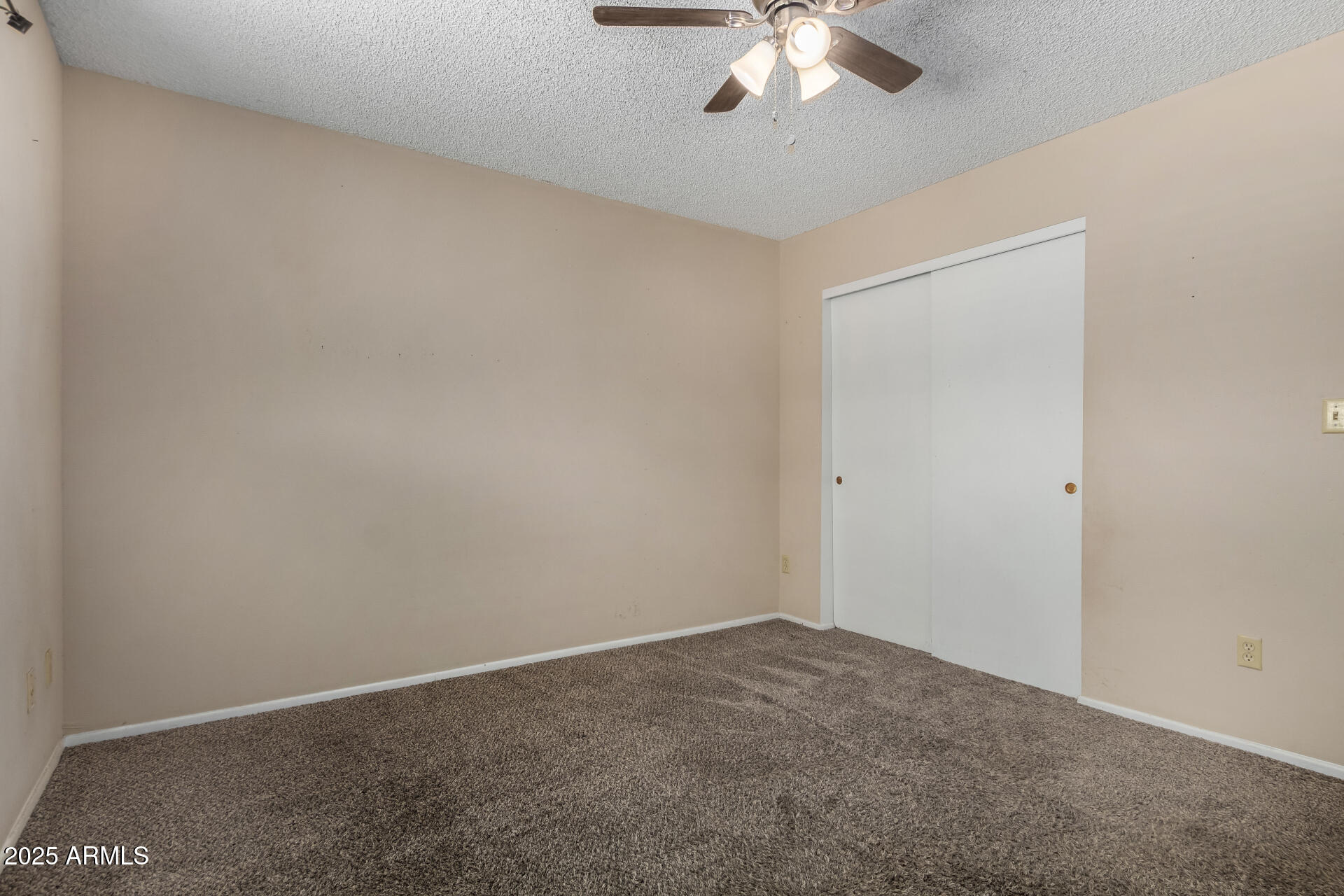 1510 South Lawther Drive Apache Junction, AZ 85120 - Photo 25 of 30 an empty room with a chandelier fan