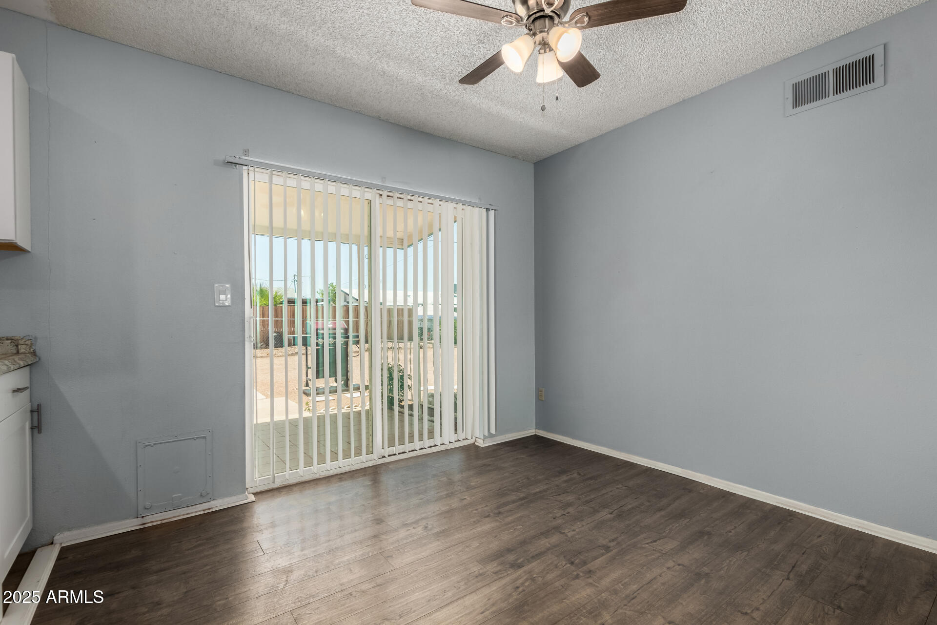 1510 South Lawther Drive Apache Junction, AZ 85120 - Photo 5 of 30 a view of an empty room with wooden floor and a window