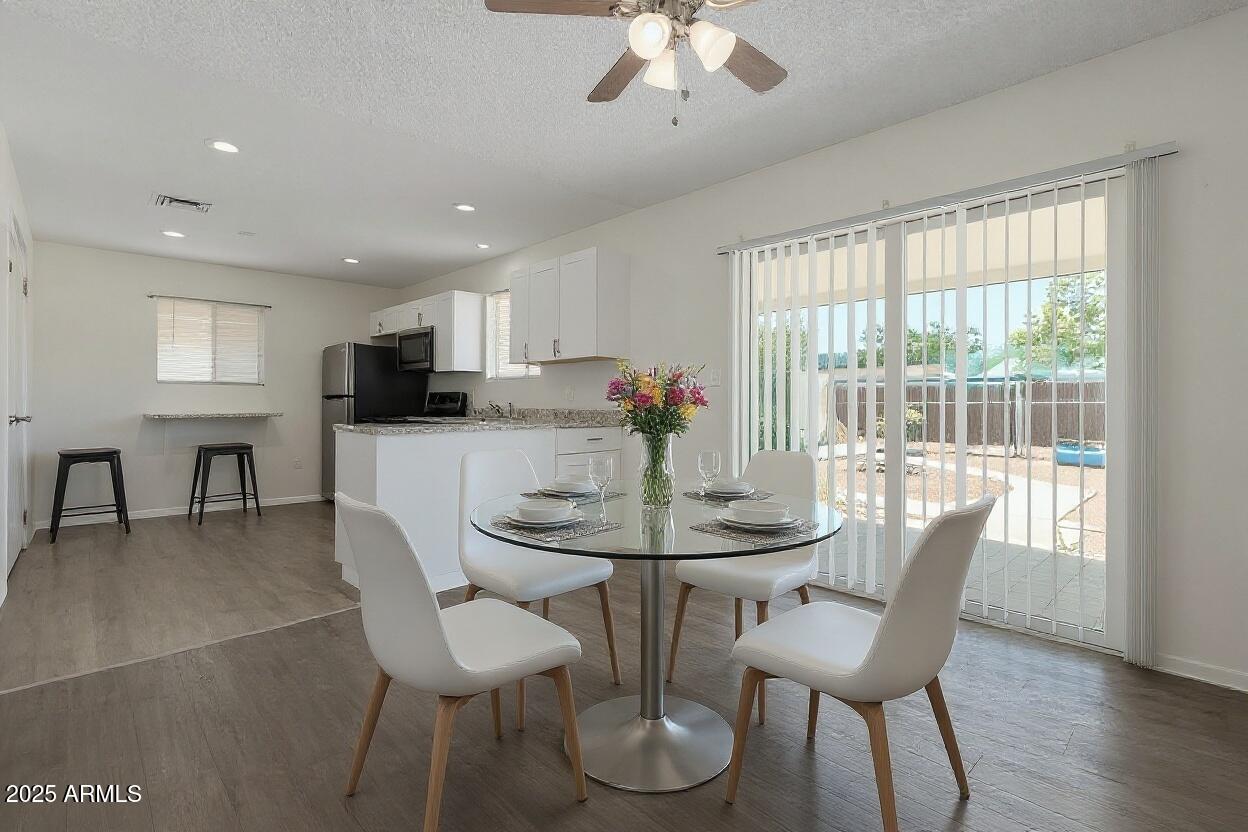 1510 South Lawther Drive Apache Junction, AZ 85120 - Photo 6 of 30 a view of a dining room with furniture and wooden floor