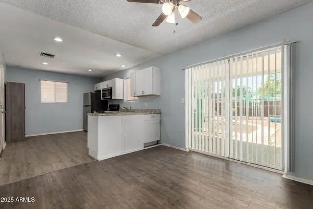 a view of kitchen with stainless steel appliances refrigerator oven and cabinets