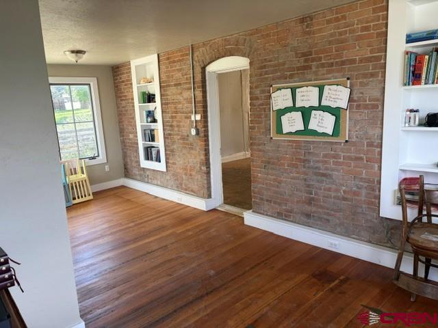 116 South Mary Street Ridgway, CO 81432 - Photo 12 of 23 an empty room with wooden floor and windows
