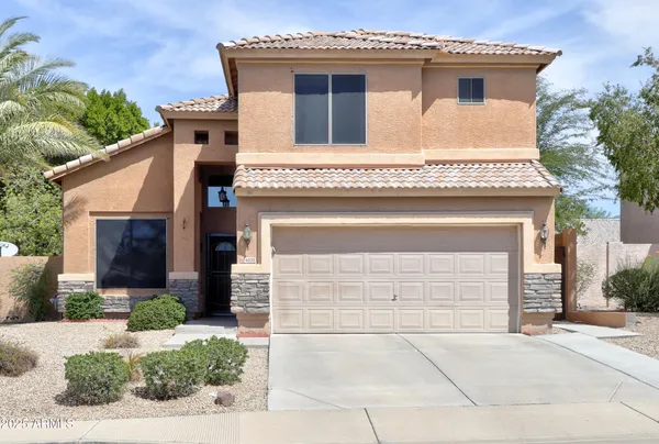 a front view of a house with a garage