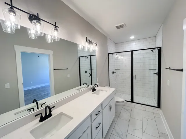 a bathroom with a sink double vanity and a mirror