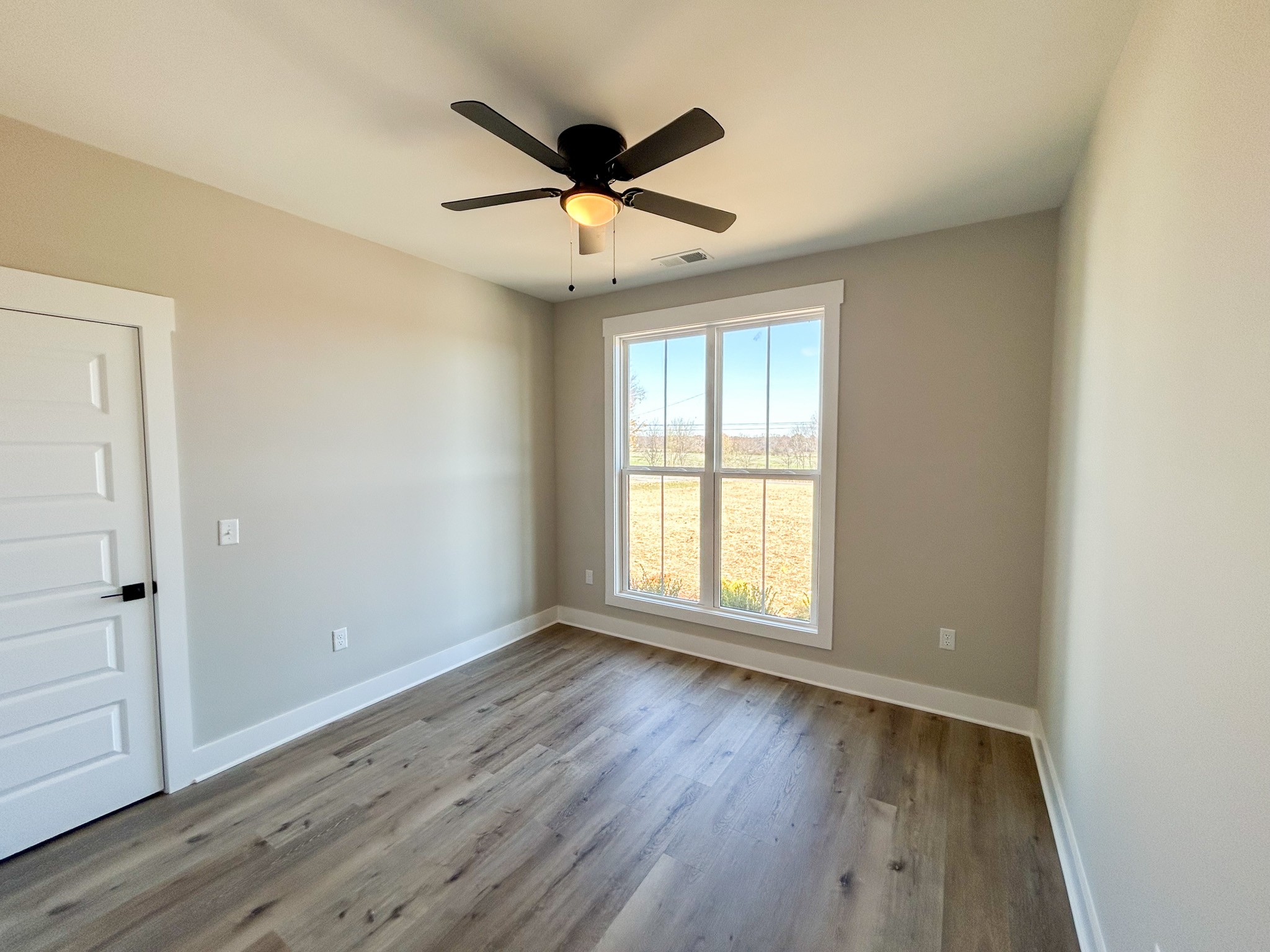977 Hoodoo Road Beechgrove, TN 37018 - Photo 16 of 22 a view of empty room with wooden floor and fan