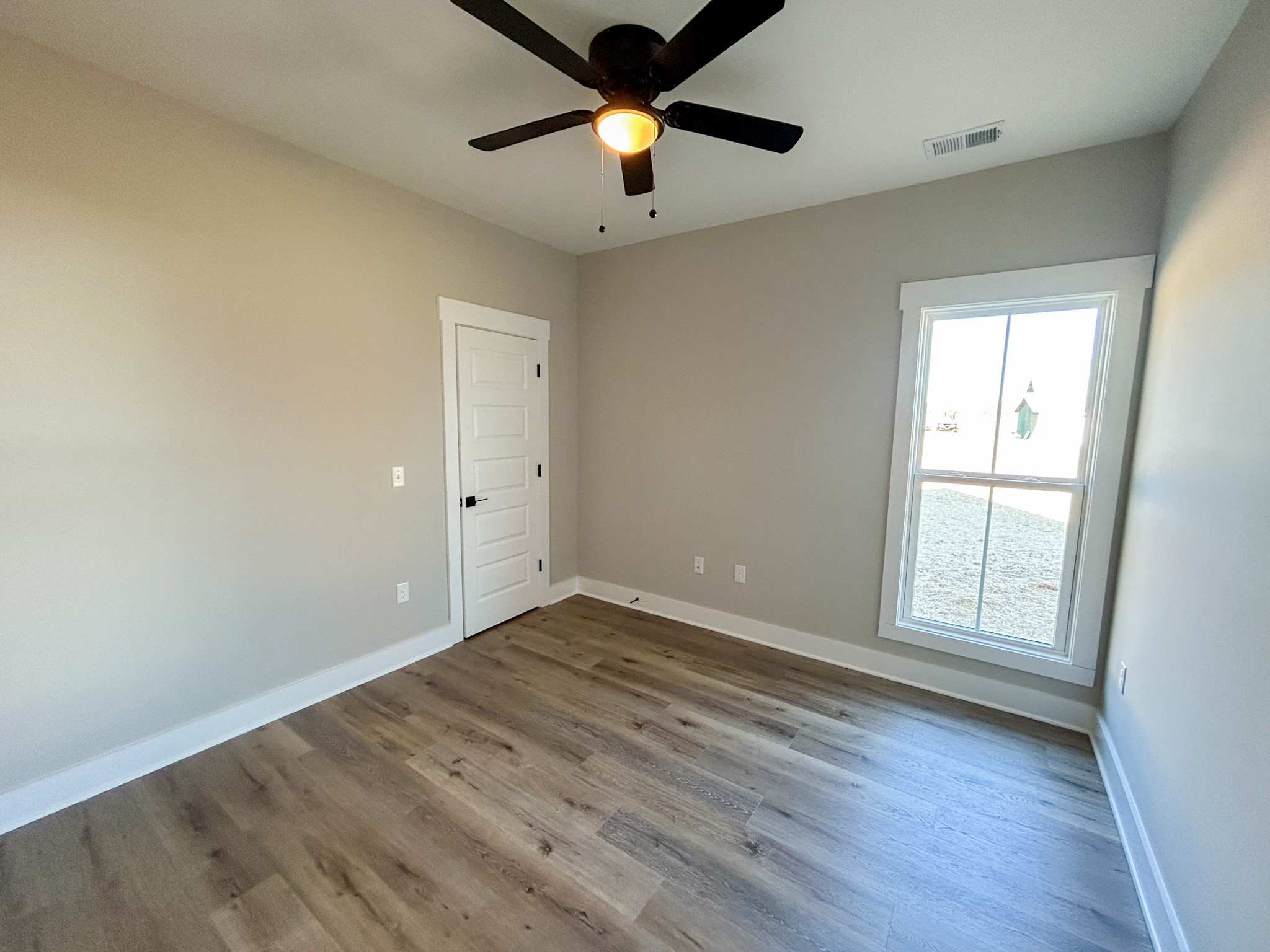 977 Hoodoo Road Beechgrove, TN 37018 - Photo 18 of 22 wooden floor in an empty room with a window