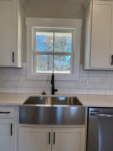 a kitchen with granite countertop a sink and a window