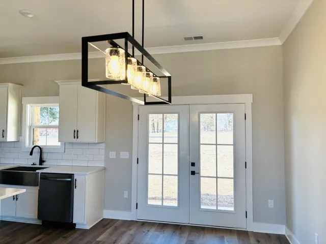 a kitchen with stainless steel appliances granite countertop a sink and a window