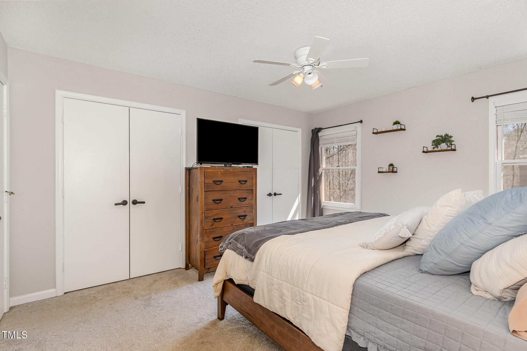 7708 Foxwood Drive Raleigh, NC 27615 - Photo 13 of 25 a bedroom with a bed and a flat screen tv