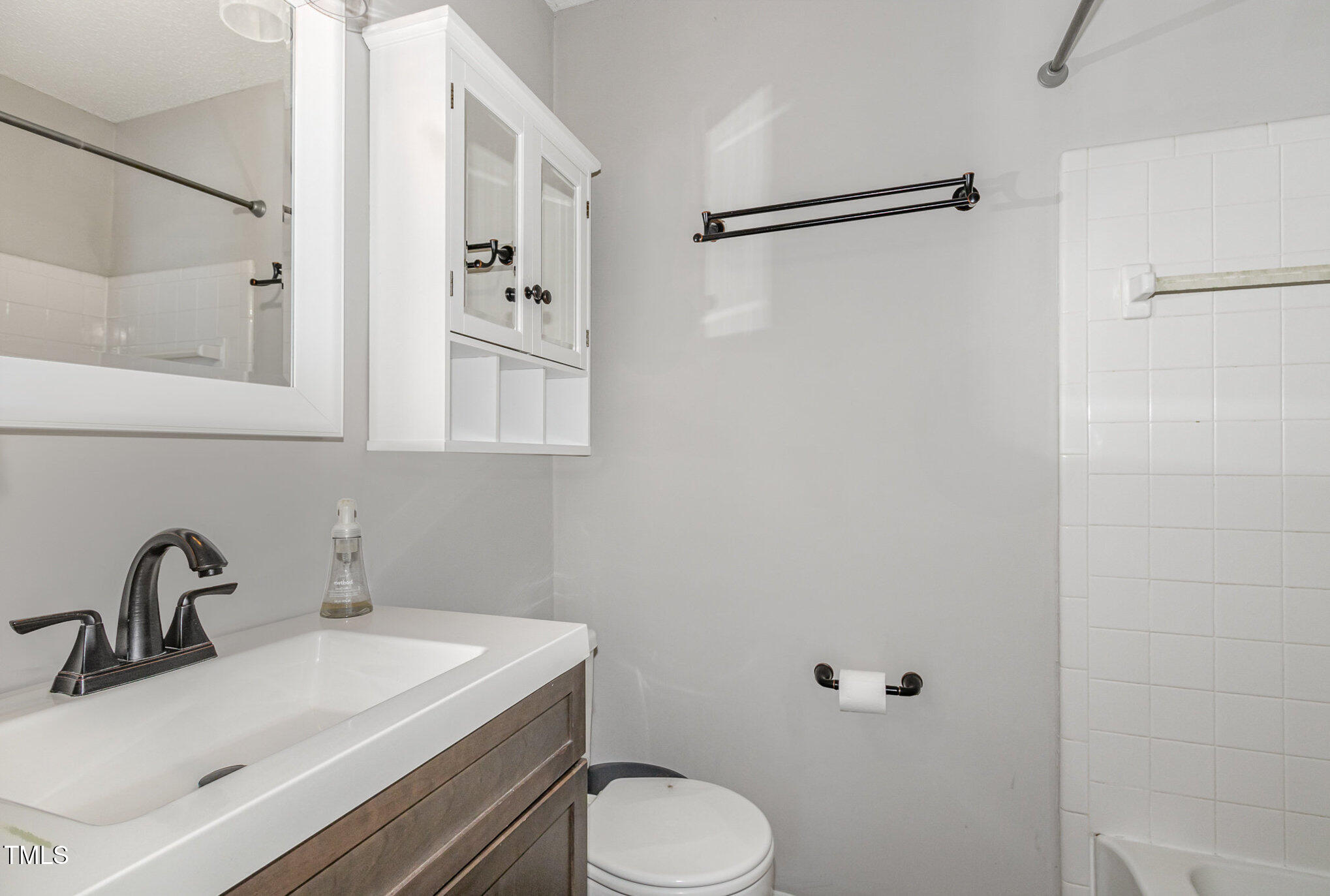 7708 Foxwood Drive Raleigh, NC 27615 - Photo 14 of 25 a bathroom with a sink toilet and vanity