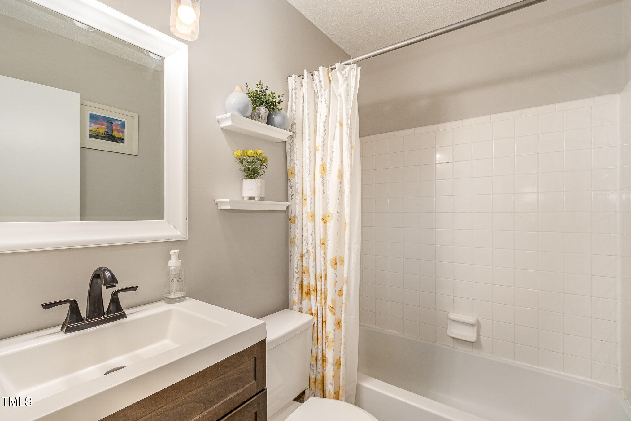 7708 Foxwood Drive Raleigh, NC 27615 - Photo 18 of 25 a bathroom with a sink and a mirror