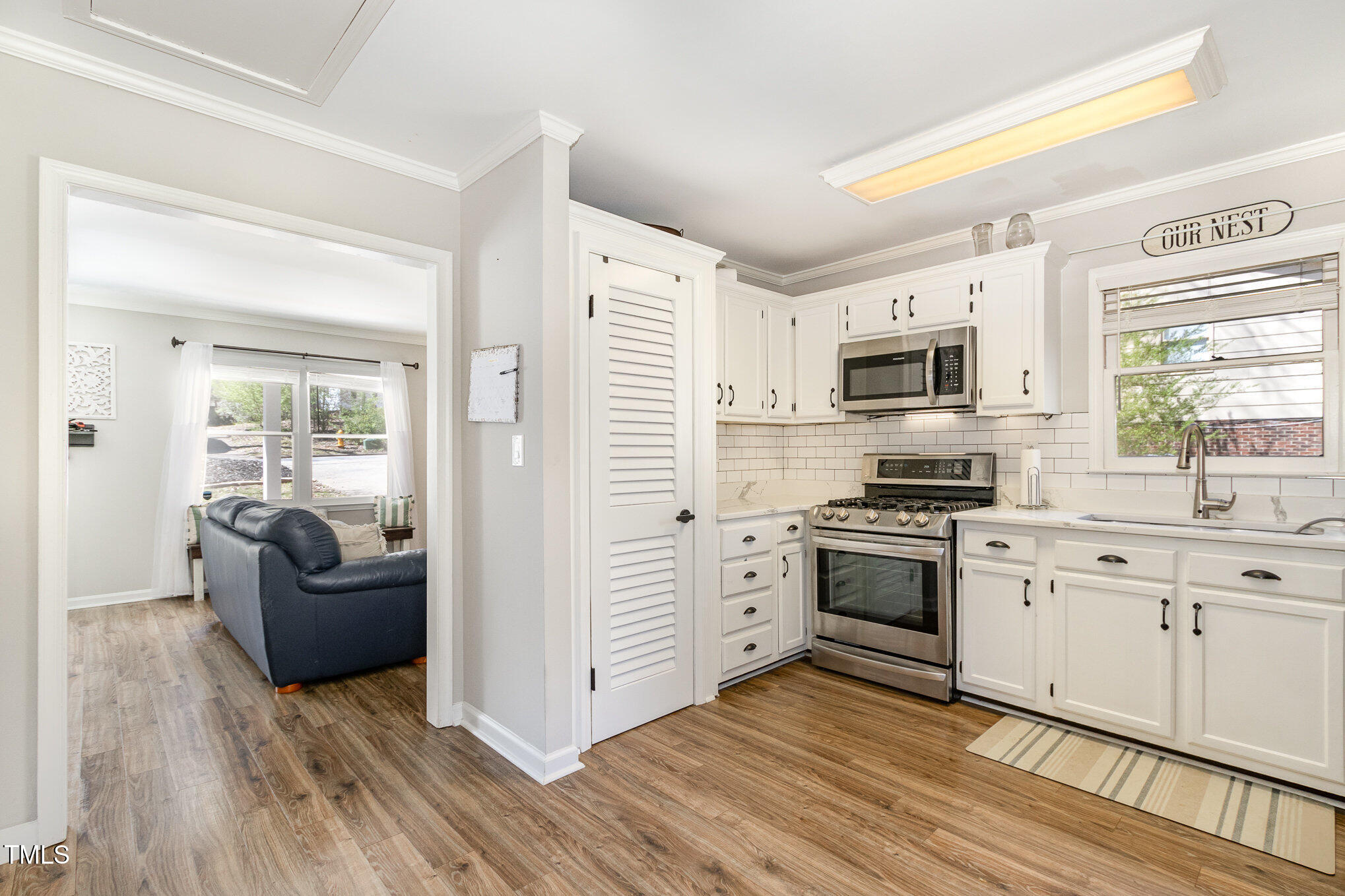 7708 Foxwood Drive Raleigh, NC 27615 - Photo 2 of 25 a kitchen with cabinets wooden floor and stainless steel appliances