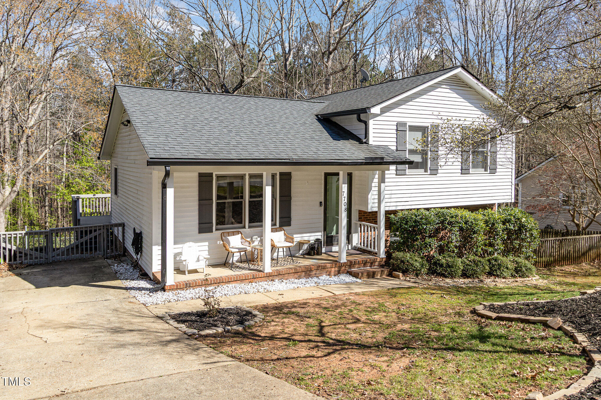 7708 Foxwood Drive Raleigh, NC 27615 - Photo 24 of 25 a front view of a house with a yard and seating space