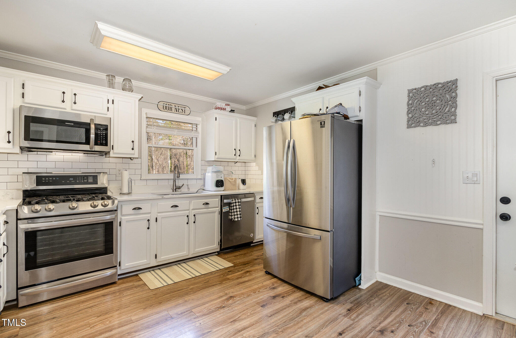 7708 Foxwood Drive Raleigh, NC 27615 - Photo 3 of 25 a kitchen with granite countertop a refrigerator stove and microwave