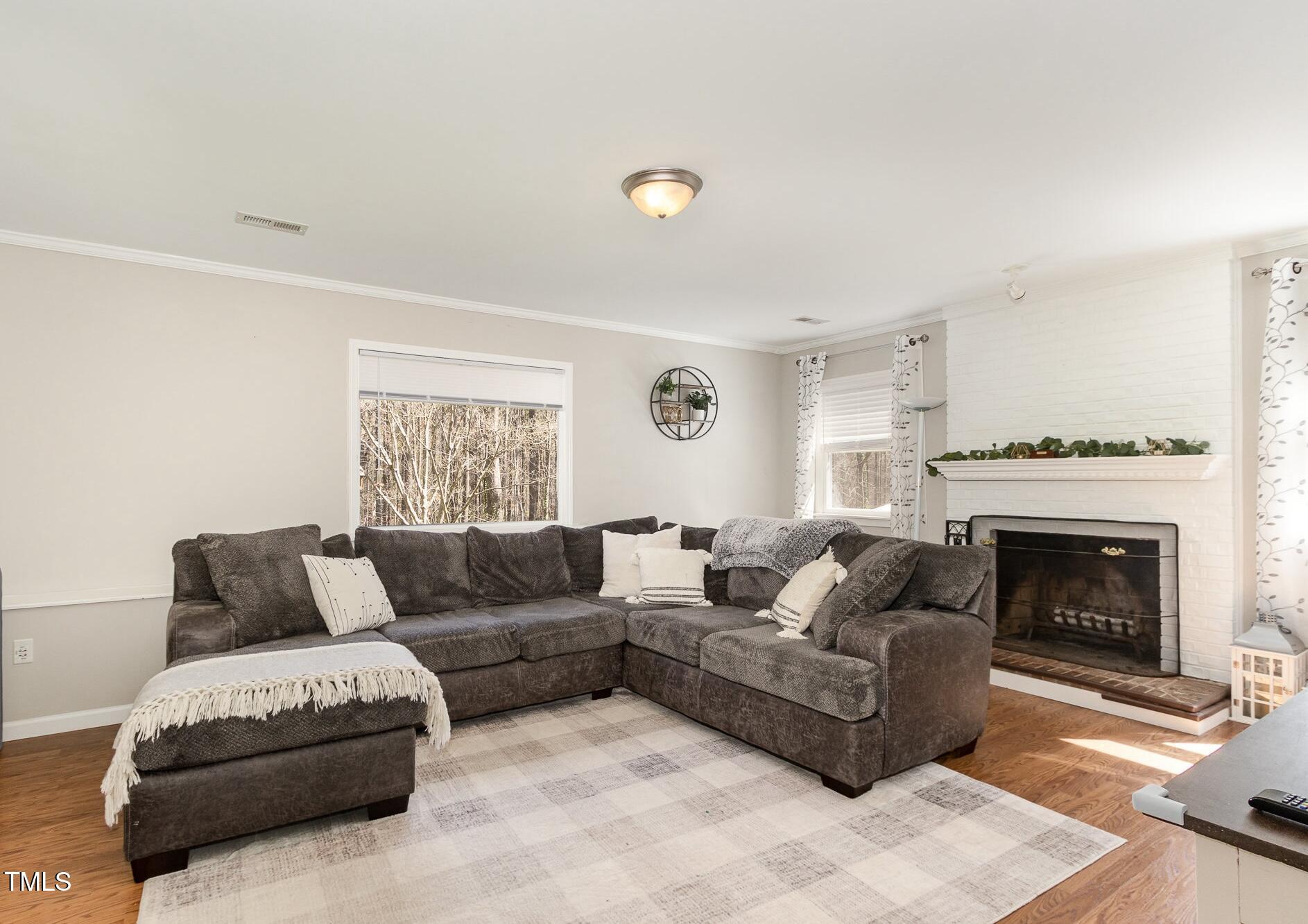 7708 Foxwood Drive Raleigh, NC 27615 - Photo 7 of 25 a living room with furniture and a fireplace