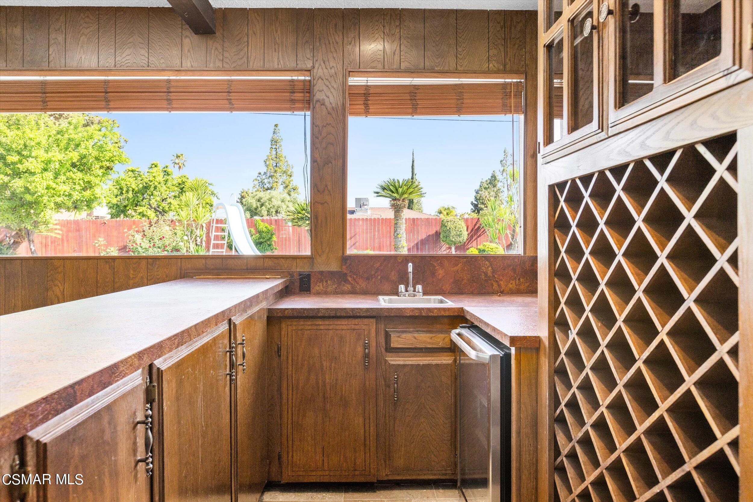 3512 Crest Drive Bakersfield, CA 93306 - Photo 17 of 40 a view of a kitchen with wooden floor and a large window