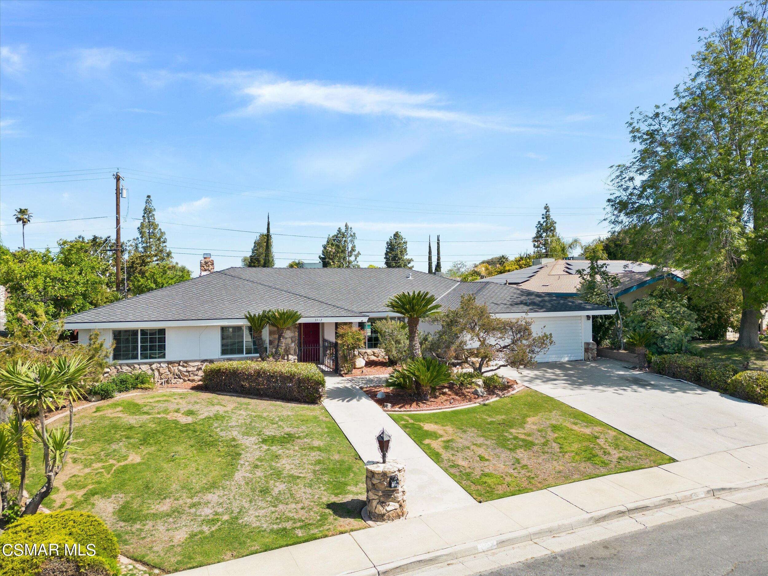3512 Crest Drive Bakersfield, CA 93306 - Photo 2 of 40 a view of a patio with table and chairs under an umbrella