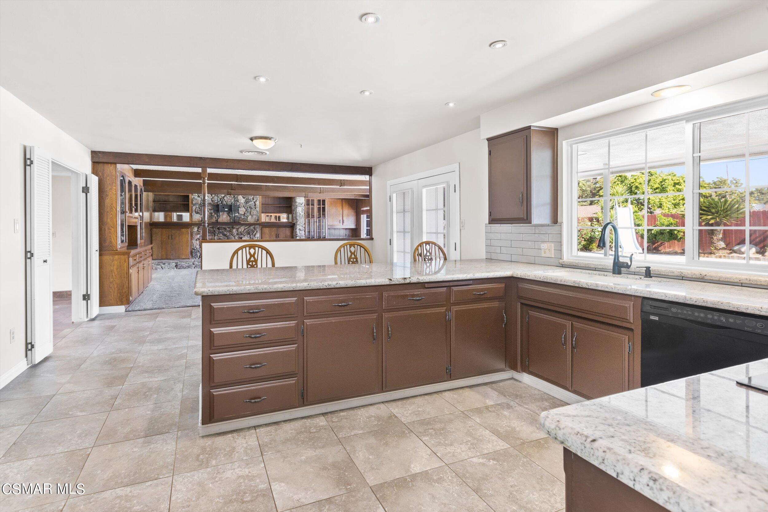 3512 Crest Drive Bakersfield, CA 93306 - Photo 25 of 40 a kitchen with stainless steel appliances kitchen island granite countertop a sink and cabinets