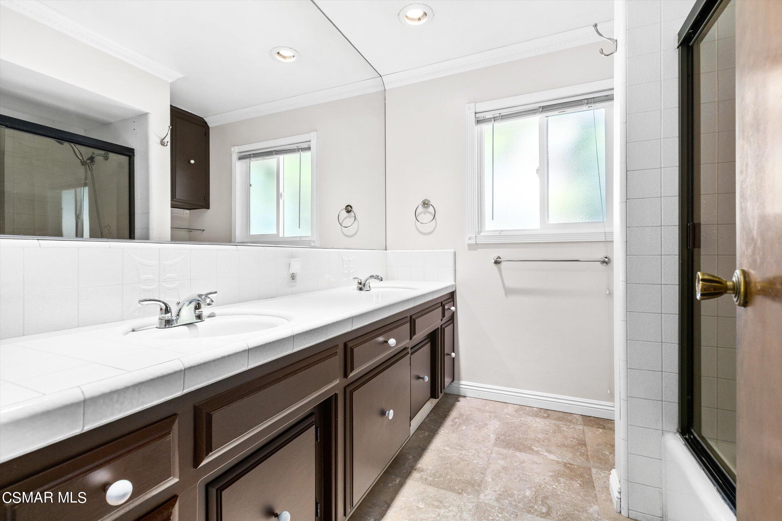 3512 Crest Drive Bakersfield, CA 93306 - Photo 31 of 40 a spacious bathroom with a granite countertop sink and a mirror