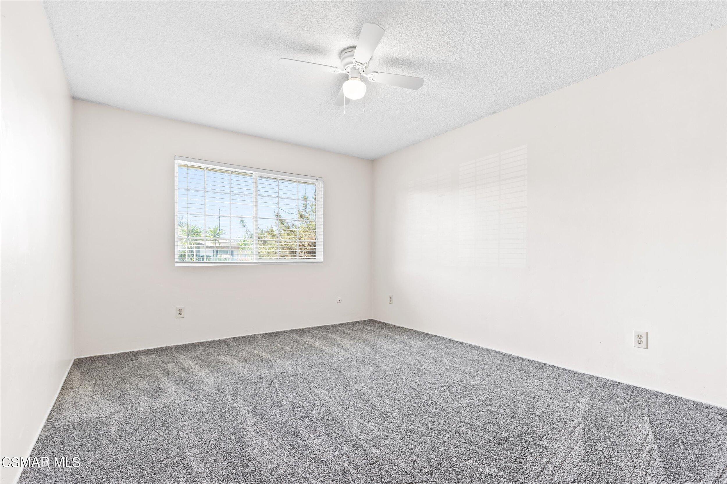 3512 Crest Drive Bakersfield, CA 93306 - Photo 32 of 40 an empty room with fan and windows
