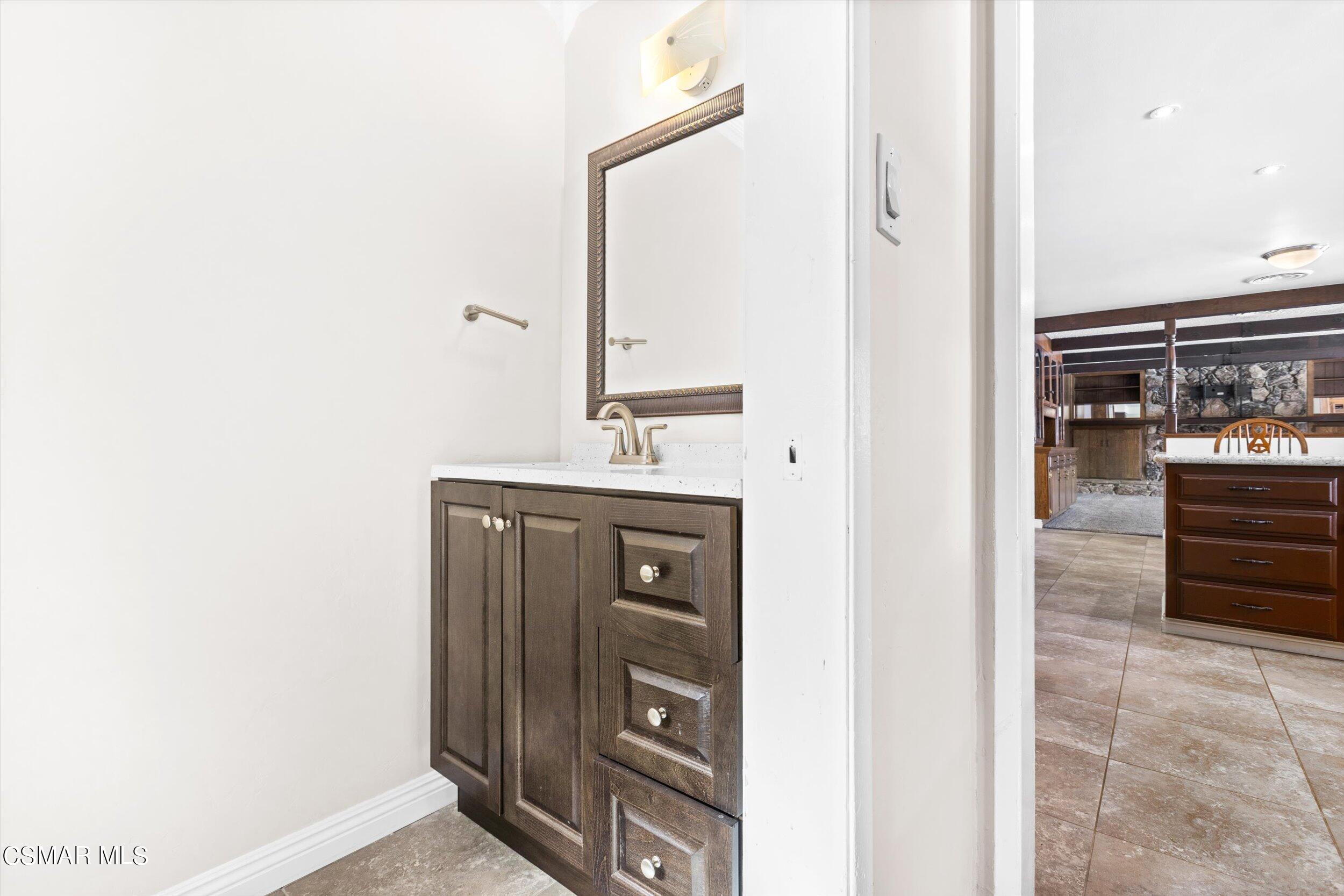 3512 Crest Drive Bakersfield, CA 93306 - Photo 34 of 40 a bathroom with a sink a vanity and a mirror