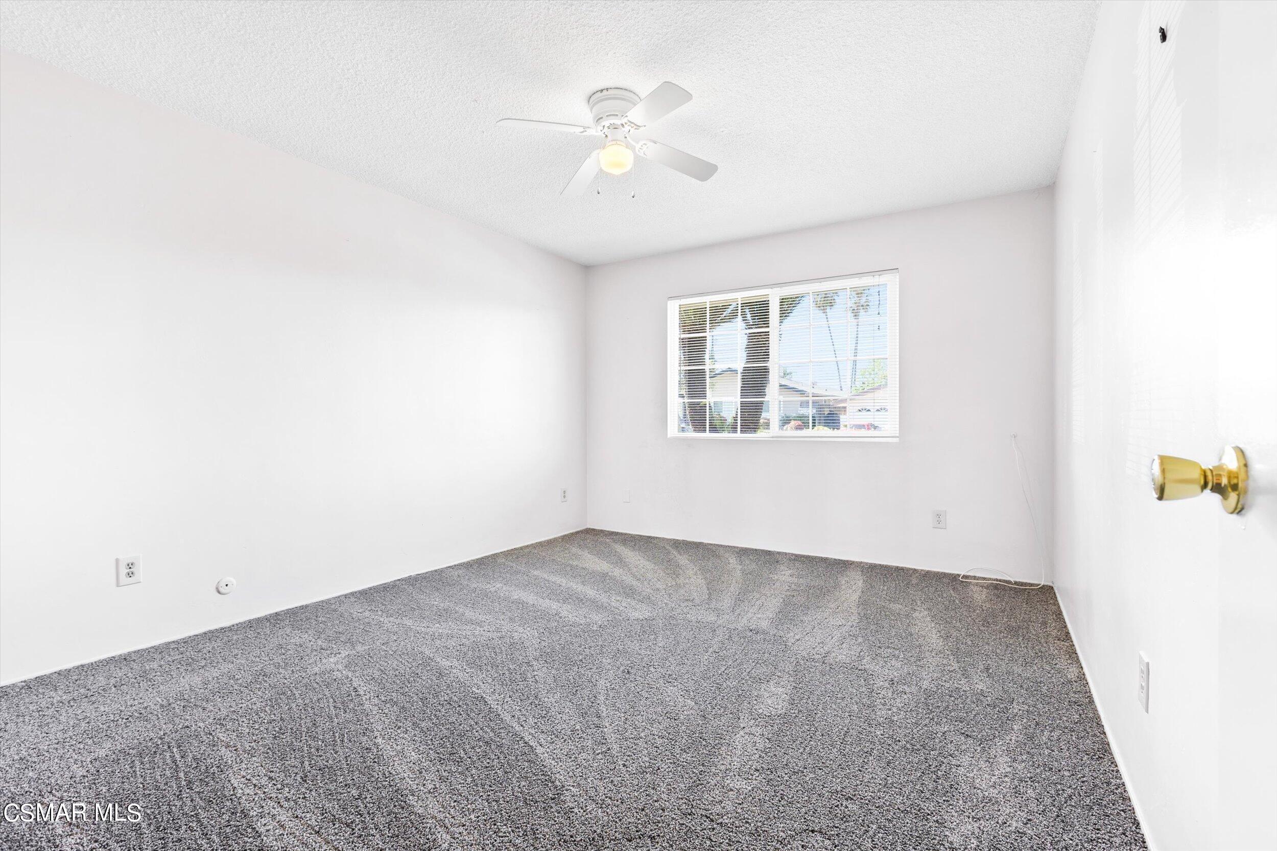 3512 Crest Drive Bakersfield, CA 93306 - Photo 35 of 40 an empty room with windows and fan