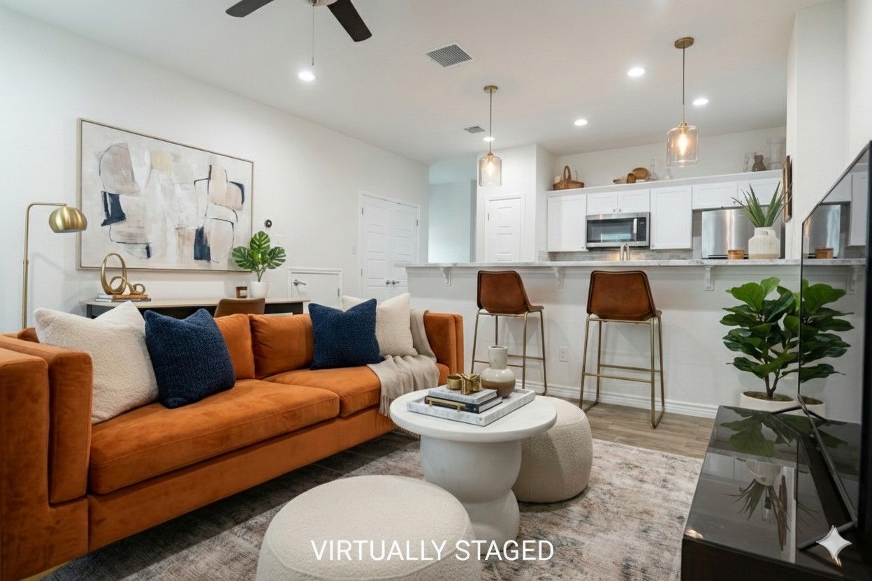a living room with furniture kitchen view and a potted plant