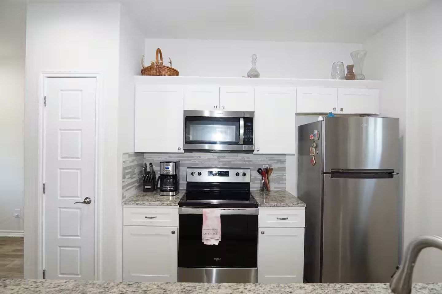 2540 Contour Drive Spring Branch, TX 78070 - Photo 4 of 12 a kitchen with a refrigerator stove and white cabinets