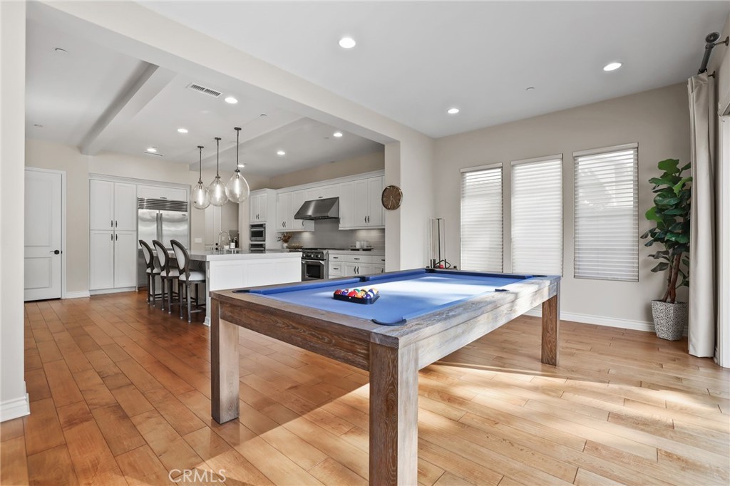 10 Shadybend Irvine, CA 92602 - Photo 20 of 70 a kitchen with stainless steel appliances kitchen island granite countertop a table chairs and a view of living room