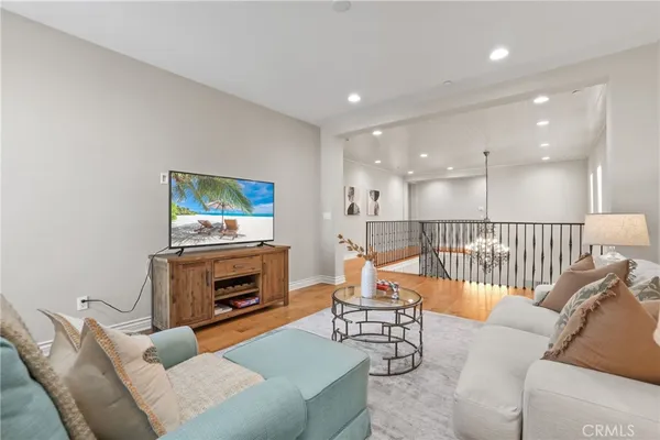 a spacious bedroom with a bed a couch and a view of bedroom