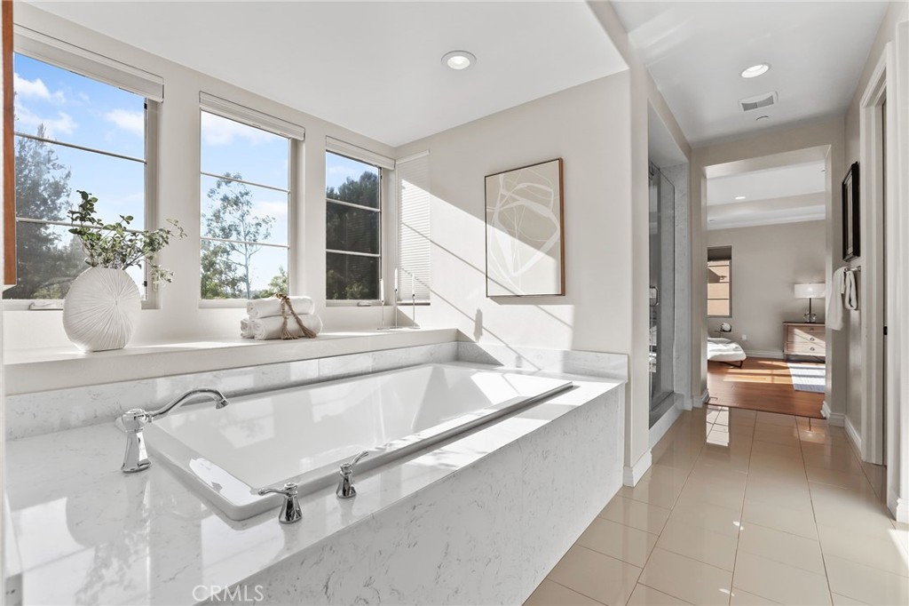 10 Shadybend Irvine, CA 92602 - Photo 46 of 70 a spacious bathroom with a tub sink and mirror