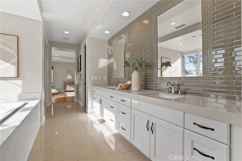 10 Shadybend Irvine, CA 92602 - Photo 48 of 70 a spacious bathroom with a double vanity sink a mirror and a bathtub